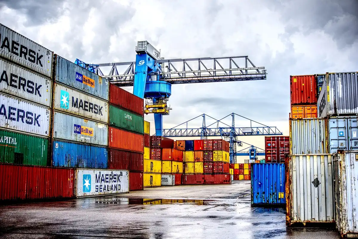 Terminal portuale europeo con gru e container in movimentazione
